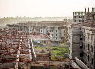 Two construction workers in Koye, the largest condominium site under construction outside Addis Abeba. Photograph: Charlie Rosser